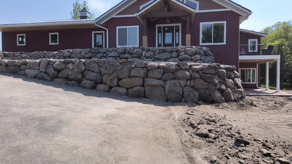 boulder retaining wall by house