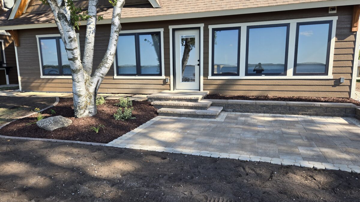 Back of lake home paver patio and flagstone walkway