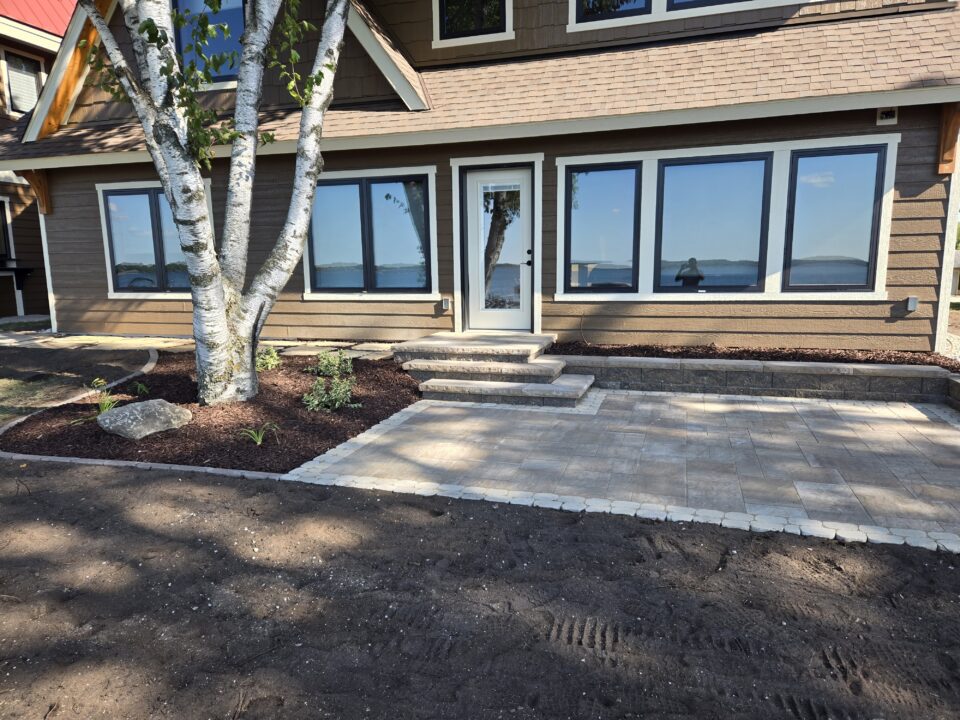 Back of lake home paver patio and flagstone walkway