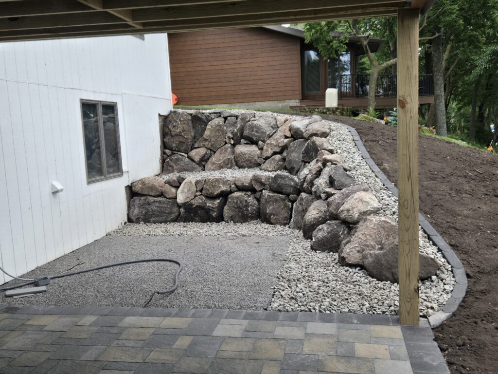 Boulder wall and edging by deck patio