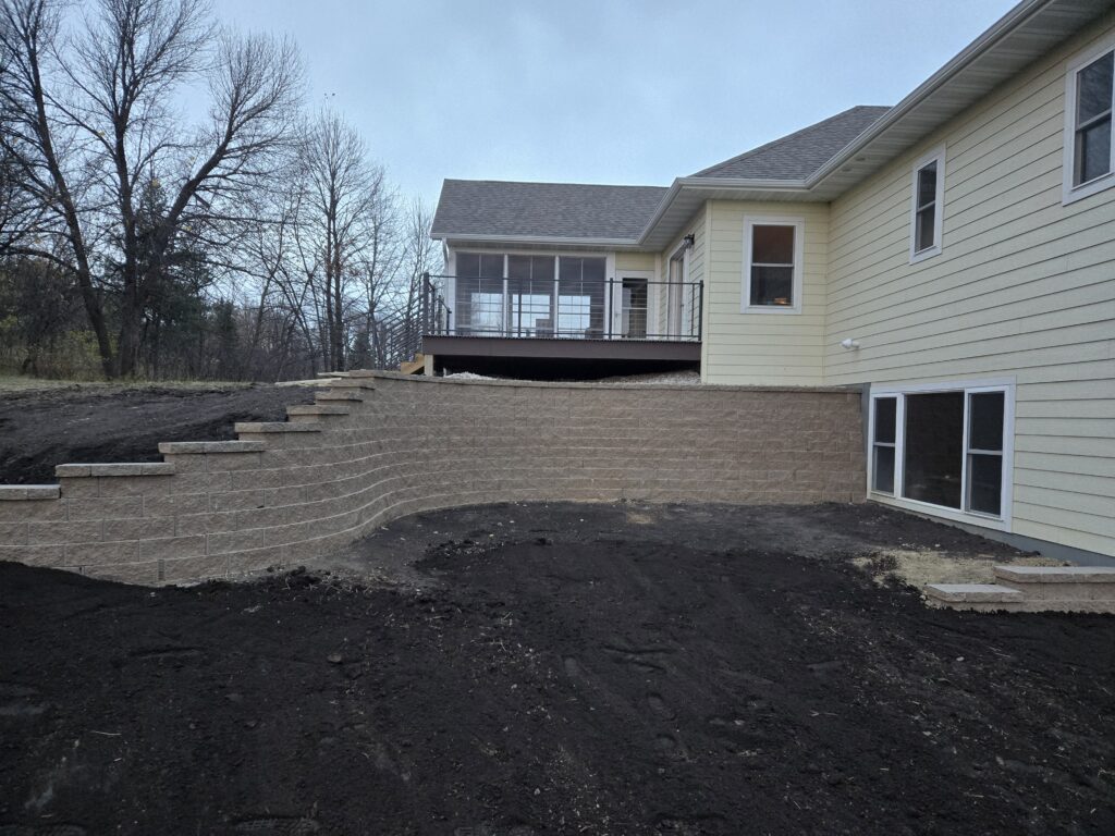 Large retaining wall on side of house