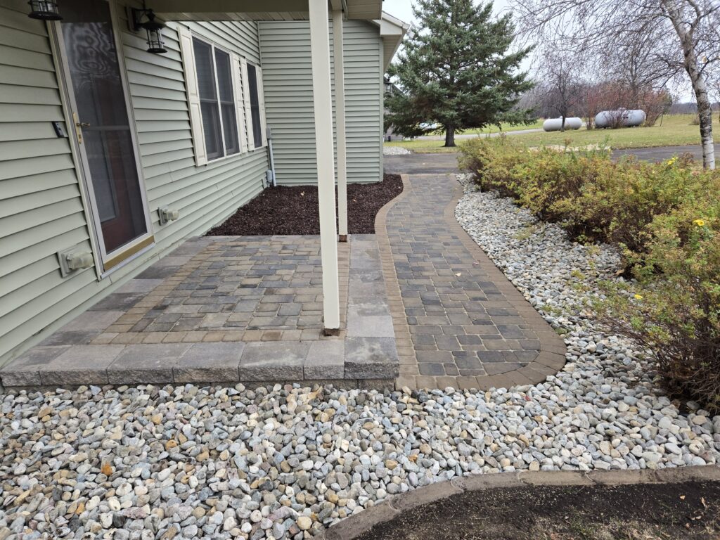 Paver landing and sidewalk connecting to driveway