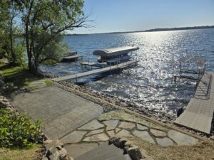 Paver patio and flagstone walkway leading to a dock in Alexandria MN